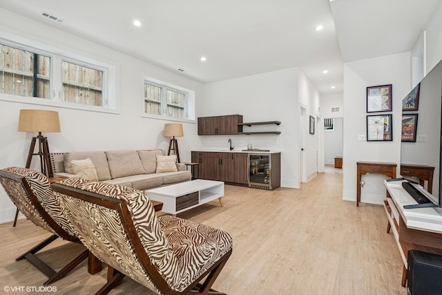 4535 S Evans Ave, Chicago, IL 60653 - living area with beverage cooler, light wood-style floors, recessed lighting, and wet bar