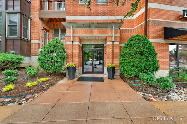 930 Curtiss St Unit 104, Downers Grove, IL 60515 - doorway to property featuring french doors and brick siding
