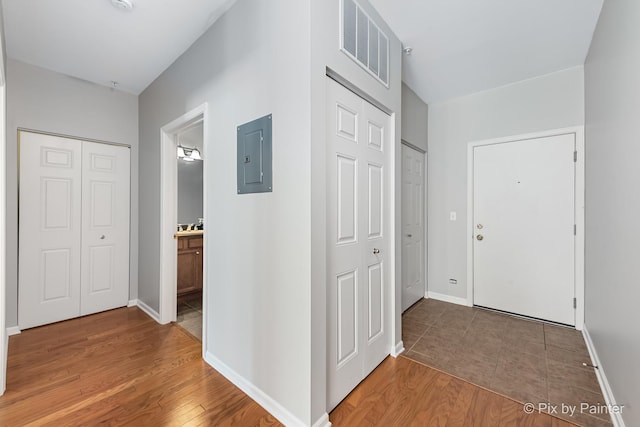 930 Curtiss St Unit 104, Downers Grove, IL 60515 - hallway with electric panel and light wood-type flooring