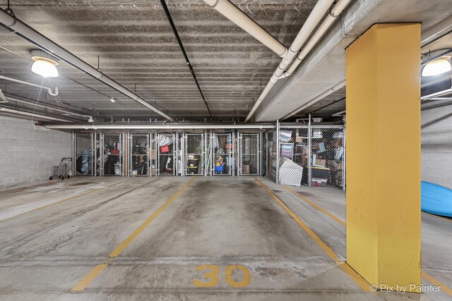 930 Curtiss St Unit 104, Downers Grove, IL 60515 - parking deck featuring concrete block wall