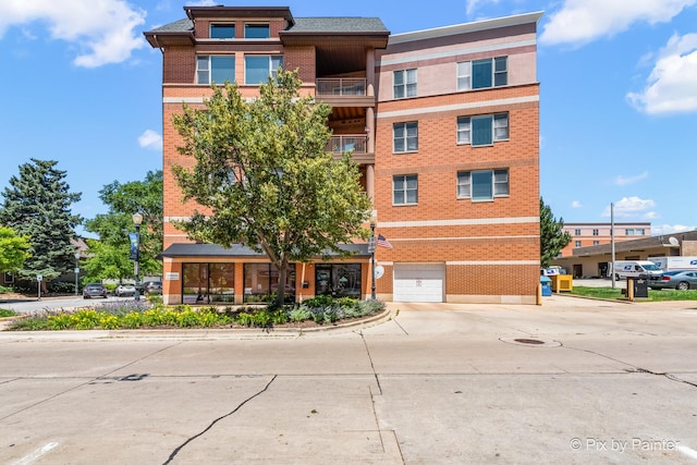930 Curtiss St Unit 104, Downers Grove, IL 60515 - view of building exterior featuring driveway and a garage