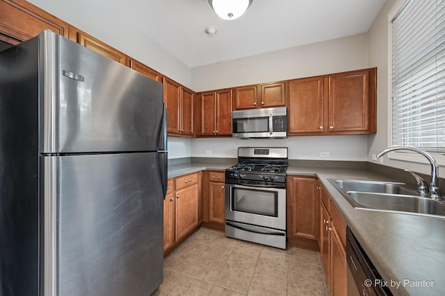 930 Curtiss St Unit 104, Downers Grove, IL 60515 - kitchen featuring appliances with stainless steel finishes, brown cabinetry, and light tile patterned floors