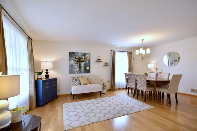 2146 Prairie Trl, Round Lake Heights, IL 60073 - dining room with a chandelier and light wood-style floors