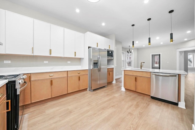 7719 S Morgan St, Chicago, IL 60620 - kitchen featuring appliances with stainless steel finishes, light wood-style floors, light countertops, recessed lighting, and hanging light fixtures