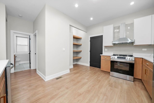 7719 S Morgan St, Chicago, IL 60620 - kitchen with stainless steel range, wall chimney range hood, light countertops, light wood finished floors, and recessed lighting