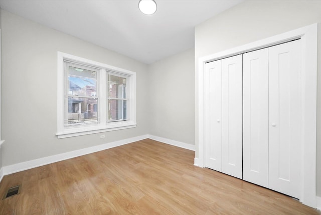 7719 S Morgan St, Chicago, IL 60620 - unfurnished bedroom featuring light wood-style floors and a closet