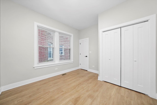 7719 S Morgan St, Chicago, IL 60620 - unfurnished bedroom with light wood finished floors and a closet