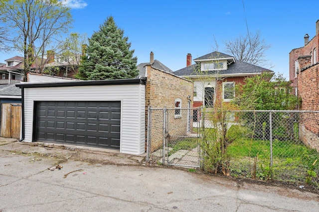 7719 S Morgan St, Chicago, IL 60620 - view of front of house with a gate, a detached garage, and brick siding