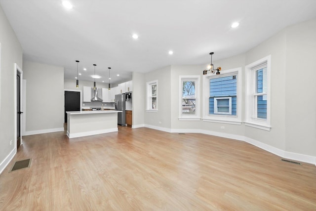 7719 S Morgan St, Chicago, IL 60620 - unfurnished living room with recessed lighting, light wood-type flooring, and a chandelier