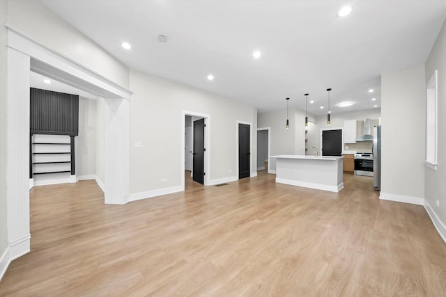 7719 S Morgan St, Chicago, IL 60620 - unfurnished living room featuring light wood-style floors, recessed lighting, and stairs