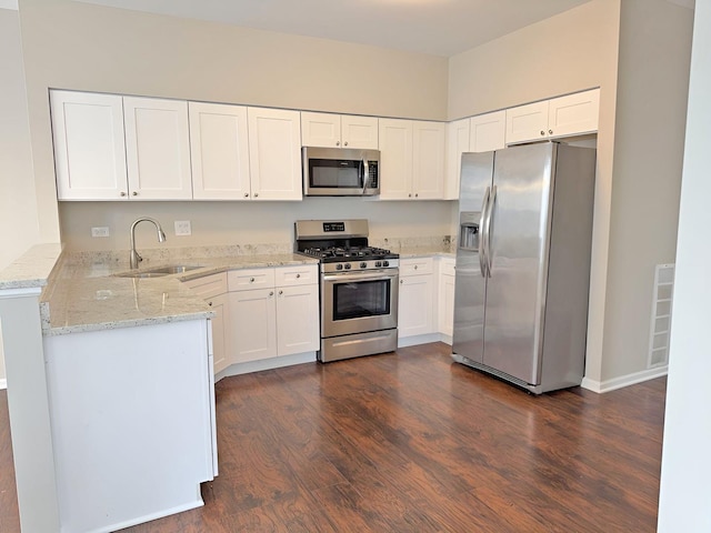 1214 Eric Ln, Lake Zurich, IL 60047 - kitchen featuring appliances with stainless steel finishes, dark wood-style floors, light stone countertops, and white cabinetry