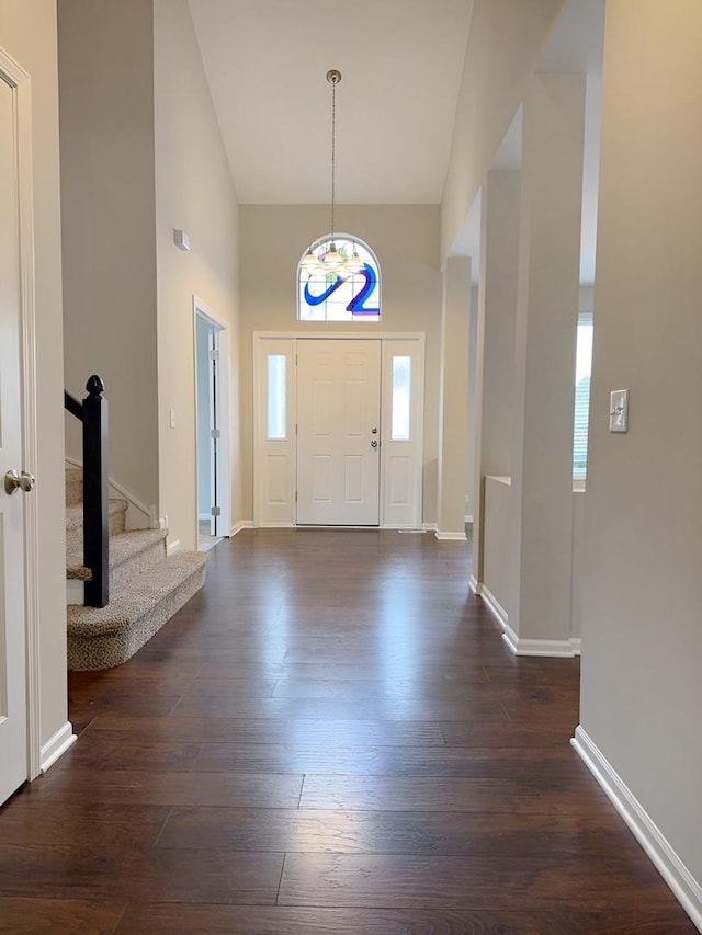 1214 Eric Ln, Lake Zurich, IL 60047 - foyer entrance featuring a chandelier, dark wood-style flooring, stairway, and high vaulted ceiling