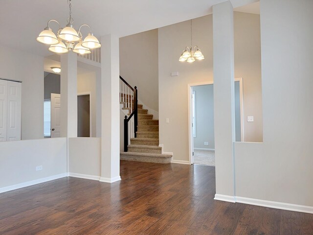 1214 Eric Ln, Lake Zurich, IL 60047 - empty room with a chandelier, dark wood-style flooring, stairway, and a high ceiling