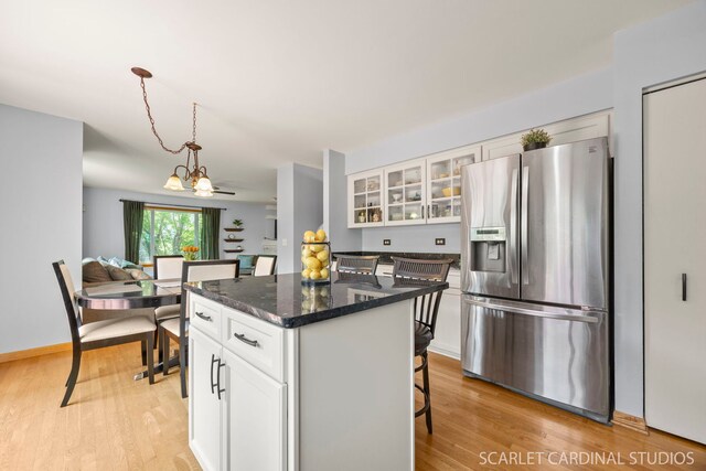 908 Pimpernel Ct, Naperville, IL 60540 - kitchen with stainless steel fridge, a kitchen island, light wood-style flooring, and a breakfast bar