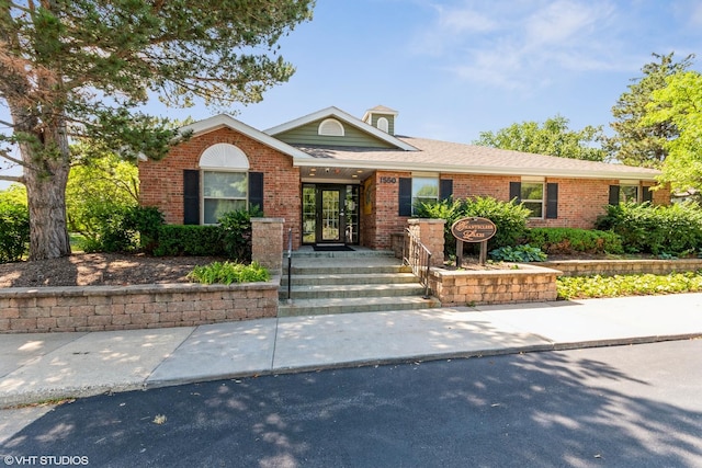 1505 Raymond Dr Unit 103, Naperville, IL 60563 - view of front facade featuring brick siding and french doors