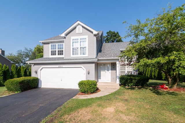 2211 Aspen Dr, Woodstock, IL 60098 - traditional-style house with an attached garage, a front lawn, asphalt driveway, and roof with shingles
