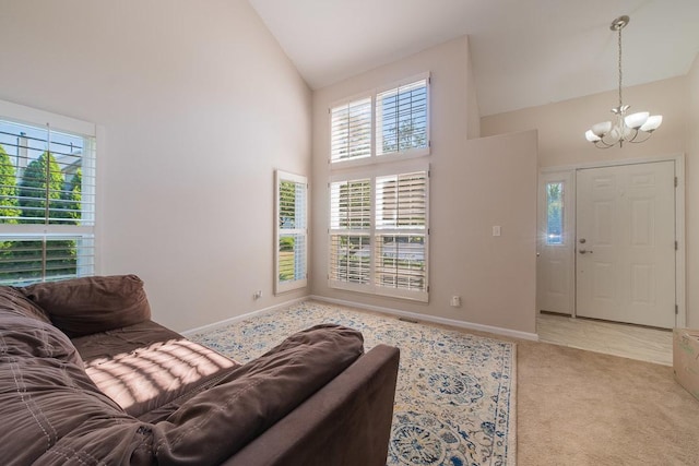 2211 Aspen Dr, Woodstock, IL 60098 - carpeted living area featuring high vaulted ceiling, a chandelier, and plenty of natural light