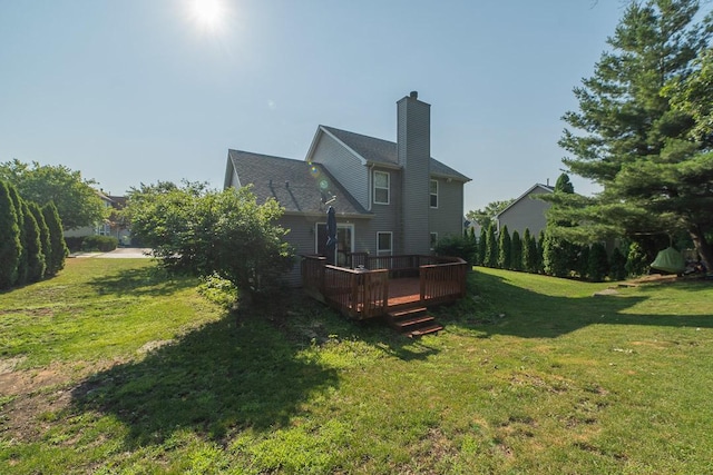 2211 Aspen Dr, Woodstock, IL 60098 - rear view of house with a chimney, a yard, and a deck