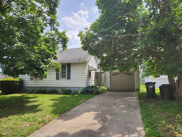 711 Avenue E Ave E, Sterling, IL 61081 - obstructed view of property with concrete driveway, a garage, a front lawn, and a shingled roof