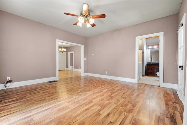 605 W 2nd N St, Wenona, IL 61377 - spare room with ceiling fan, a chandelier, and light wood finished floors