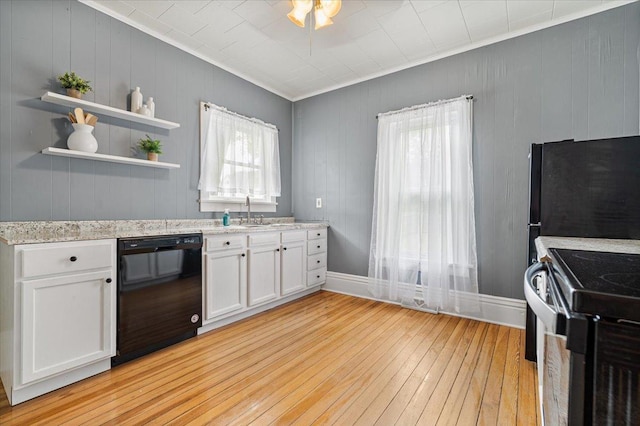 605 W 2nd N St, Wenona, IL 61377 - kitchen featuring black dishwasher, range with electric stovetop, light wood finished floors, crown molding, and white cabinets