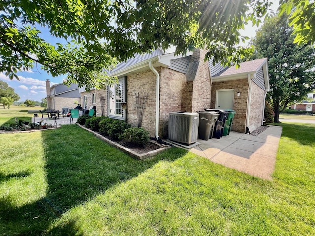 14011 Creek Crossing Dr, Orland Park, IL 60467 - view of home's exterior featuring a lawn, brick siding, a patio area, and a chimney