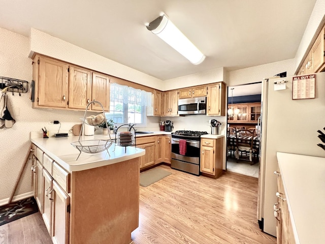 14011 Creek Crossing Dr, Orland Park, IL 60467 - kitchen with stainless steel appliances, light wood-type flooring, light countertops, a peninsula, and wallpapered walls