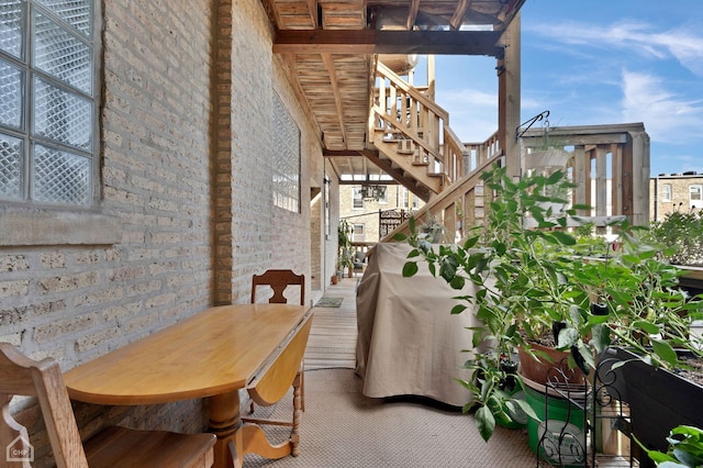 2627 N Kimball Ave Unit 2A, Chicago, IL 60647 - dining area featuring stairs, brick wall, and a towering ceiling