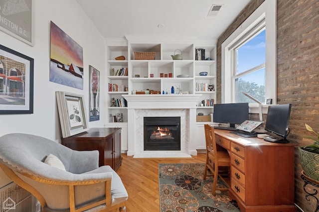 2627 N Kimball Ave Unit 2A, Chicago, IL 60647 - office space with a fireplace, light wood-style flooring, and built in shelves