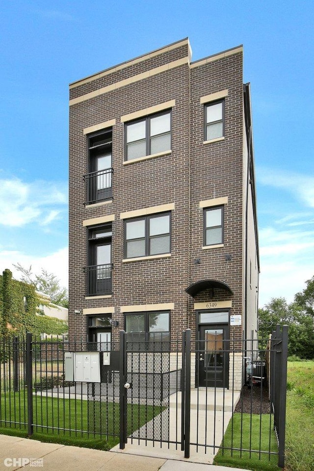 6349 S Maryland Ave, Chicago, IL 60637 - multi unit property with brick siding, a fenced front yard, and a gate