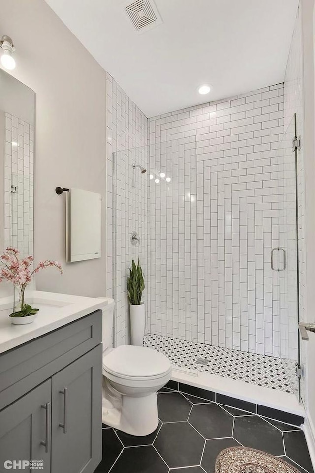 6349 S Maryland Ave, Chicago, IL 60637 - bathroom with vanity, a shower stall, and tile patterned floors