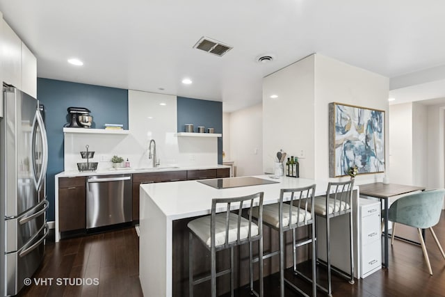 424 Park Ave Unit 604, River Forest, IL 60305 - kitchen featuring stainless steel appliances, open shelves, dark wood-style flooring, a kitchen breakfast bar, and recessed lighting