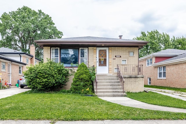 8825 S Richmond Ave, Evergreen Park, IL 60805 - view of front facade with a porch, brick siding, and a front lawn