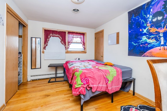 8825 S Richmond Ave, Evergreen Park, IL 60805 - bedroom featuring baseboard heating and wood finished floors