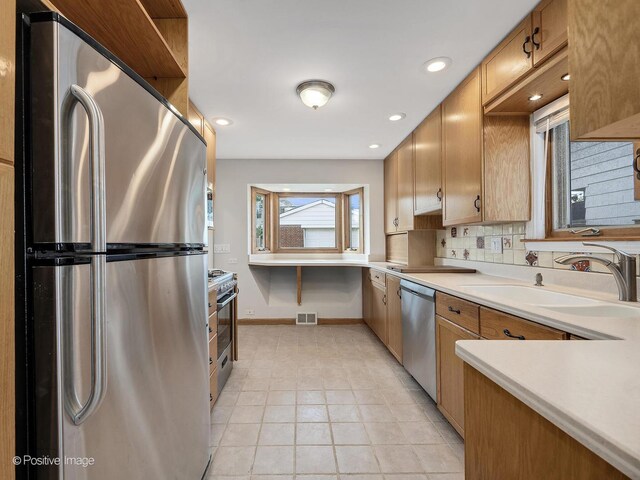 610 S Madison Ave, La Grange, IL 60525 - kitchen with appliances with stainless steel finishes, light countertops, tasteful backsplash, recessed lighting, and light tile patterned floors