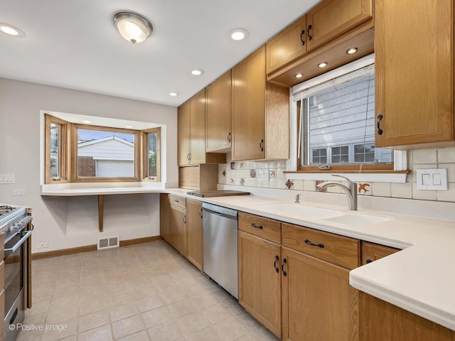 610 S Madison Ave, La Grange, IL 60525 - kitchen featuring stainless steel appliances, decorative backsplash, light countertops, and recessed lighting