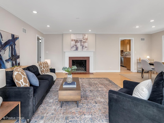 610 S Madison Ave, La Grange, IL 60525 - living area featuring light wood-type flooring, crown molding, recessed lighting, and a brick fireplace