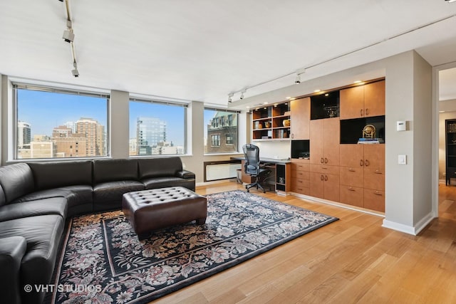 1110 N Lake Shore Dr Unit 20N, Chicago, IL 60611 - living room featuring rail lighting, built in study area, light wood-type flooring, and plenty of natural light