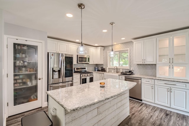 1322 E Thurston Dr, Palatine, IL 60074 - kitchen with appliances with stainless steel finishes, white cabinets, a kitchen island, and backsplash
