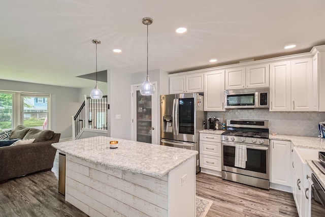 1322 E Thurston Dr, Palatine, IL 60074 - kitchen featuring stainless steel appliances, white cabinetry, open floor plan, backsplash, and recessed lighting