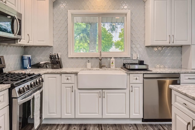 1322 E Thurston Dr, Palatine, IL 60074 - kitchen with appliances with stainless steel finishes, tasteful backsplash, white cabinetry, and light stone countertops