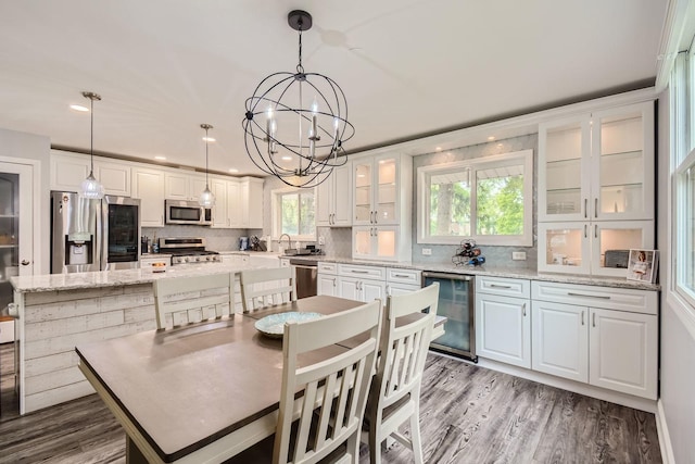 1322 E Thurston Dr, Palatine, IL 60074 - dining area with wine cooler, a chandelier, wood finished floors, and recessed lighting