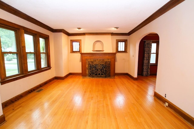 314 N Maple St, Itasca, IL 60143 - unfurnished living room with arched walkways, light wood finished floors, crown molding, and a high end fireplace