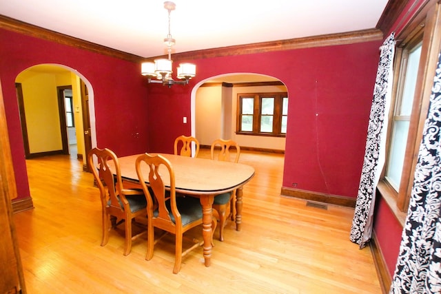 314 N Maple St, Itasca, IL 60143 - dining area with a chandelier, arched walkways, light wood-style flooring, and ornamental molding