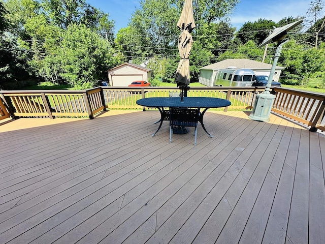 314 N Maple St, Itasca, IL 60143 - wooden deck featuring an outbuilding, outdoor dining area, and view of scattered trees