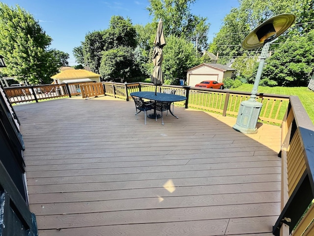 314 N Maple St, Itasca, IL 60143 - wooden deck featuring outdoor dining space, a yard, and an outdoor structure