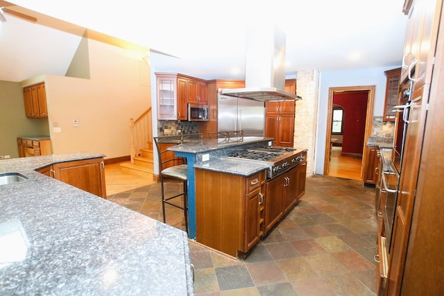 314 N Maple St, Itasca, IL 60143 - kitchen featuring stainless steel appliances, island range hood, a kitchen bar, decorative backsplash, and a kitchen island