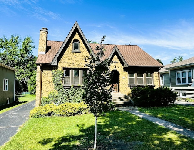 314 N Maple St, Itasca, IL 60143 - view of front of house featuring brick siding, a front lawn, a chimney, and roof with shingles