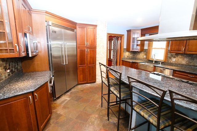 314 N Maple St, Itasca, IL 60143 - kitchen featuring stainless steel appliances, exhaust hood, decorative backsplash, and glass insert cabinets