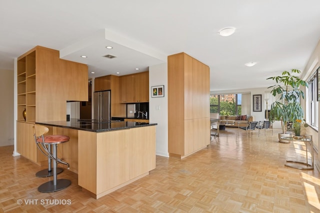 2970 N Lake Shore Dr Unit 7B-7C, Chicago, IL 60657 - kitchen featuring modern cabinets, a breakfast bar, dark stone countertops, a peninsula, and open floor plan